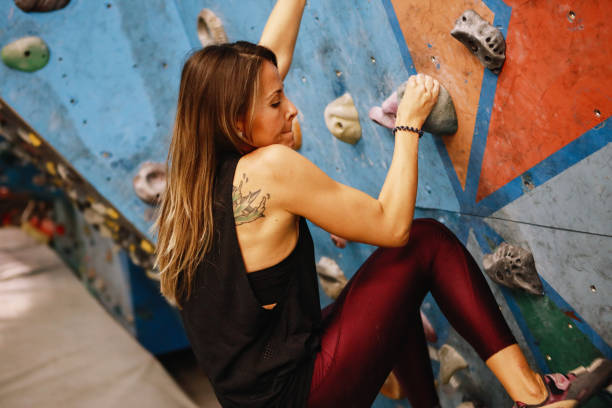 istock Young woman climbing the artificial bouldering rock 1289738763