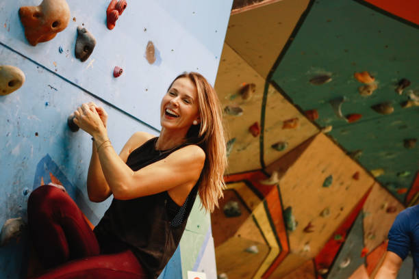 istock Young woman climbing the artificial bouldering rock 1289738909