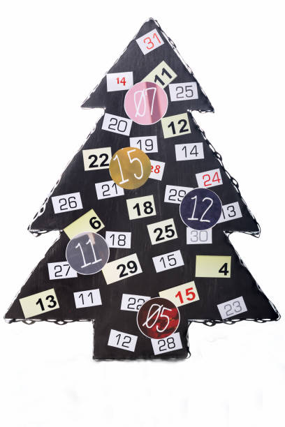 istock Artificial fir Christmas tree decorated with numbers isolated on a white background, fir tree made of wood and metal in brown color 1289741407