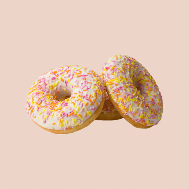 istock Sweet donuts with color glaze isolated on white background. 1289744478