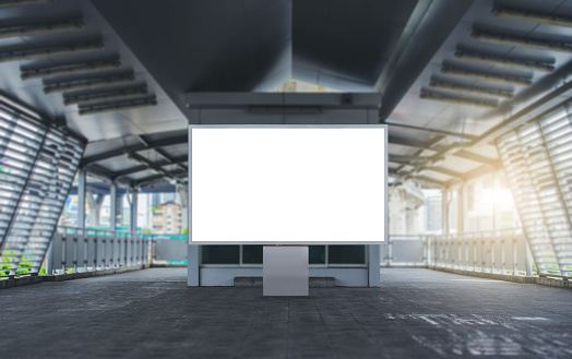 large blank advertise billboard white LED screen vertical on big pole walk way outdoor in city for design display announcement and advertising .