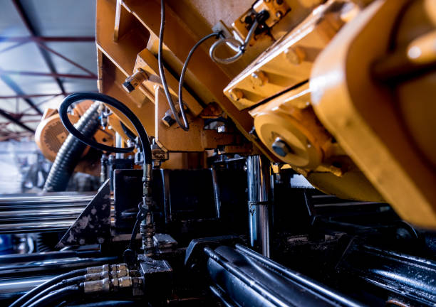 istock Automatic band saw machine with water coolant cutting metal pipes. 1289745492