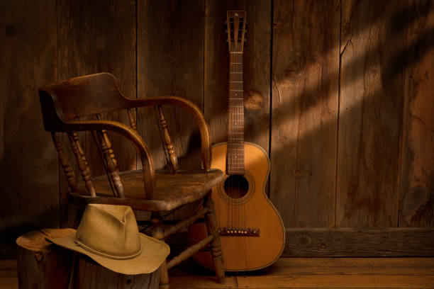 wild west scene with saloon chair, cowboy hat and vintage guitar - cowboy hat wild west hat wood imagens e fotografias de stock