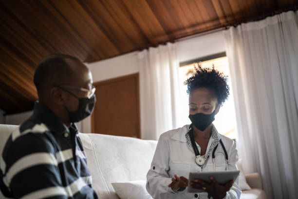 istock Doctor talking to a senior patient at home visit 1289745819