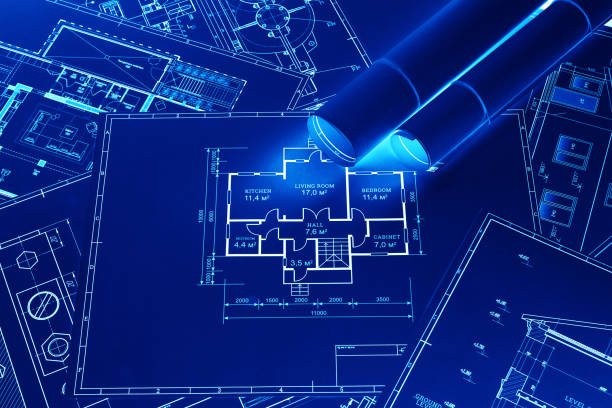 istock Blue-white construction drawings on the table. The concept of construction, architecture, design, business 1289745917
