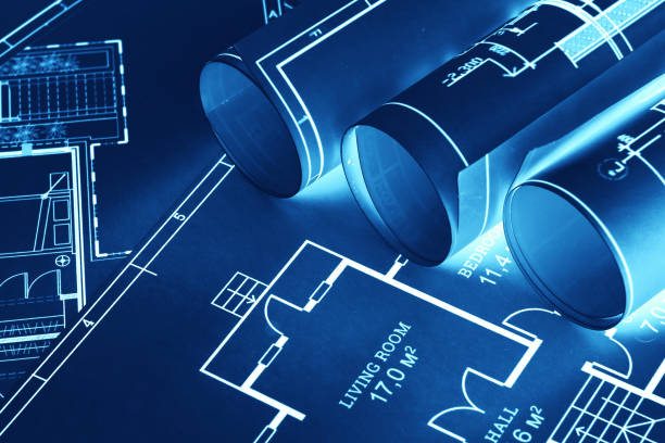 istock Blue-white construction drawings on the table. The concept of construction, architecture, design, business 1289745934