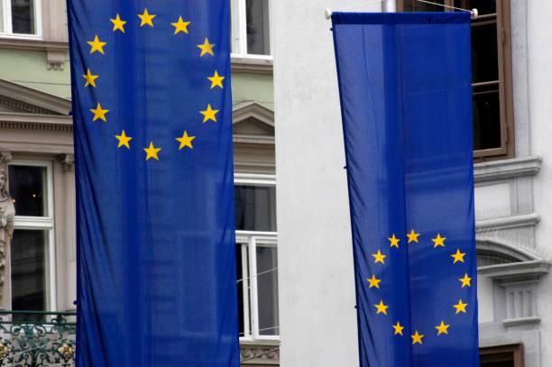istock Two EU flags in front of a building 1289746197