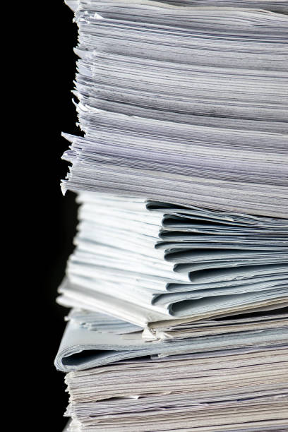 istock pile of paper documents in the office on black background 1289747163
