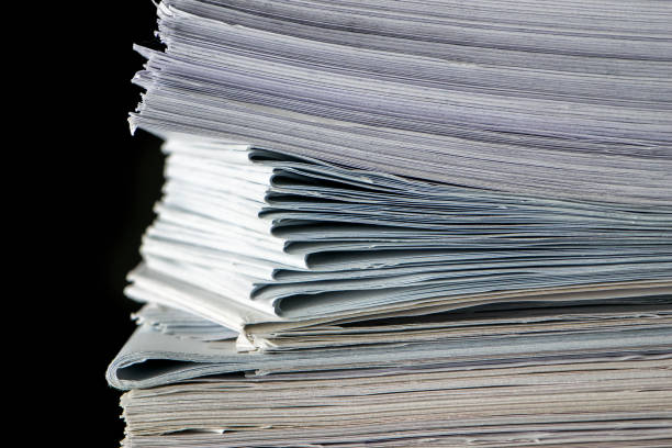 istock pile of paper documents in the office on black background 1289747166