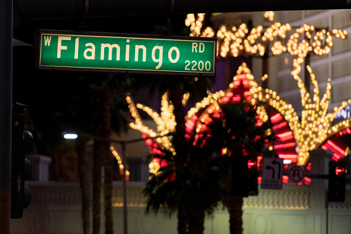 Las Vegas, USA - Sep 22, 2019: A Flamingo Road street sign early in the evening with the Flamingo Hotel in the background.