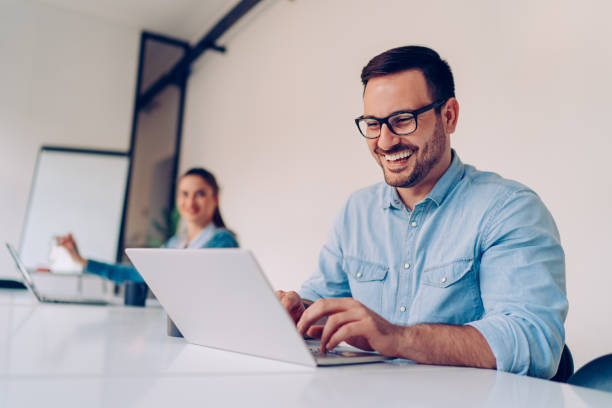istock Happy businesspeople working in the office 1289750004