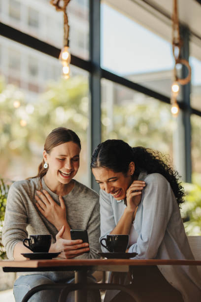 istock Friends reading a funny message on phone 1289750458