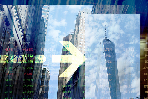 Arrow over New York Financial District buildings with Trading Screen Data. Digitally generated Image.