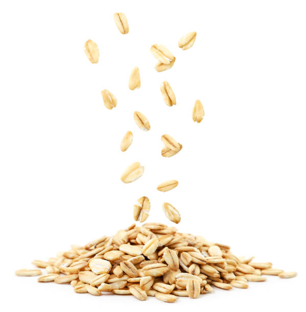 istock Raw oatmeal falls on a heap on a white background. Isolated 1289753293