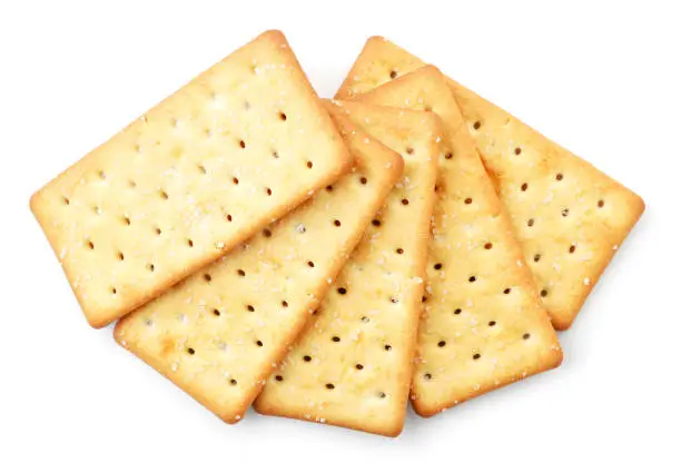 Photo of Crackers with salt on white background, isolated. The view from top