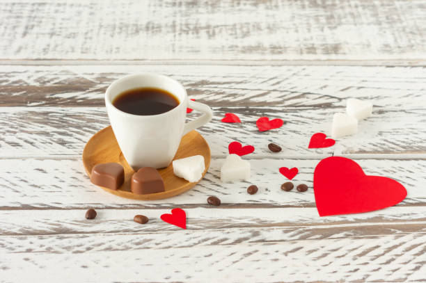 istock Festive St Valentines composition. Black romatic coffee with sugar in heart sashape and red scattered paper heart confetti 1289753505