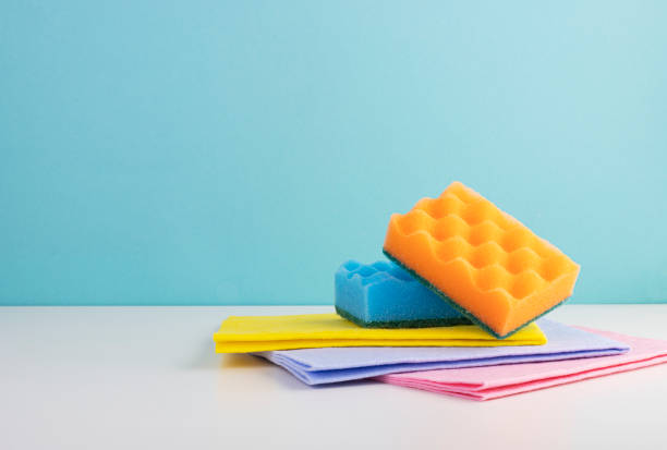 Colored kitchen napkins and colorful sponges on a blue background Colored kitchen napkins and colorful sponges on a blue background. cleaning products for home work labroides dimidiatus stock pictures, royalty-free photos & images