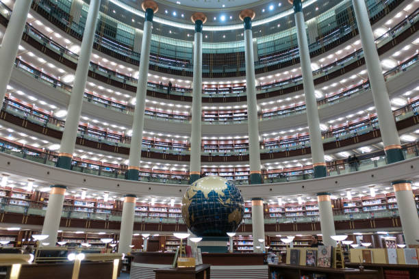 Interior view of an amazing crowded library with a globe on its center stock photo