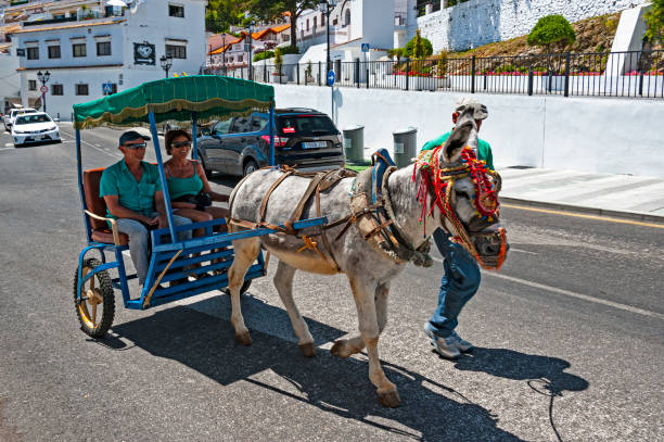 Mijas, Spain - May 22, 2017:  People take a ride around the lovely touristy town of Mijas in Andalusia