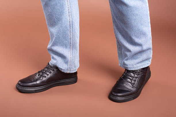 istock shoes mens shoes model jeans studio pose 1289758709