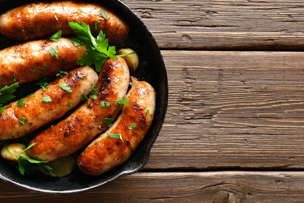 istock Roasted sausages in frying pan 1289759136