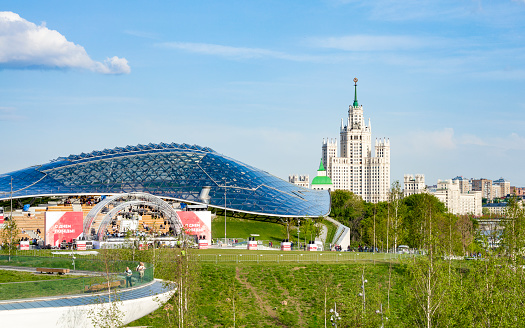 MOSCOW, RUSSIA - MAY 9, 2019- Zaryadie Park in the center of Moscow. Victory Day, May 9th. Concert Hall of Russia and Stalin on the background of a high-rise building