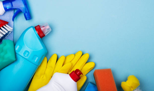 istock Home office apartment cleaning kit on blue background with space for text, top view 1289759976