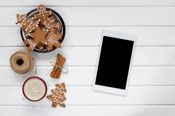 istock Christmas coffee and gingerbread cookies with digital tablet 1289760003