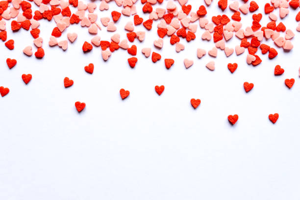 istock sprinkles background, sugar sprinkle red hearts, decoration for cake and bakery. Top view, flat lay. Valentines holiday 1289761206