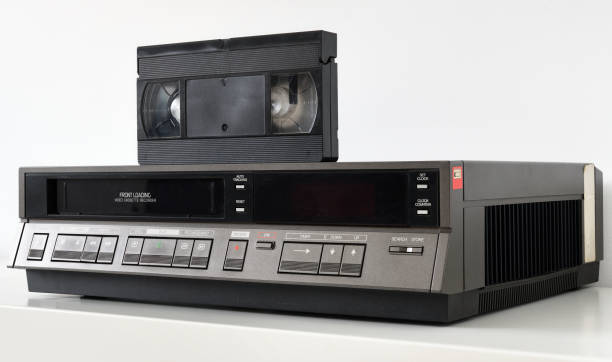 istock An old vintage videotape recorder from the 1980s stands on a white bedside table with a videotape. 1289763867