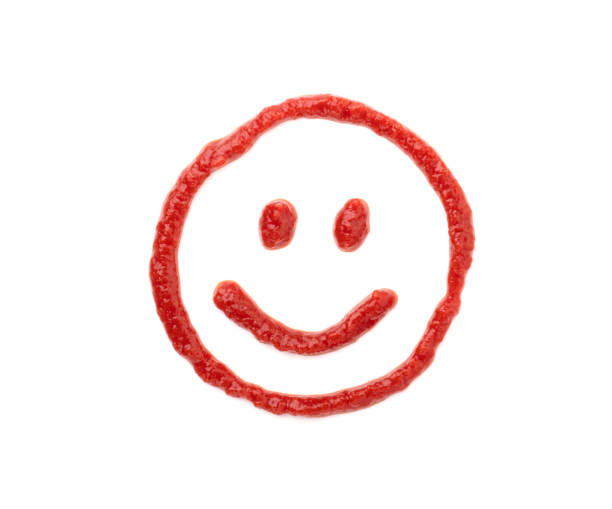 Funny food face, dumpling and ketchup. Food art on black plate. Smiling face on plate. Motivation for losing weight and healthy eating.