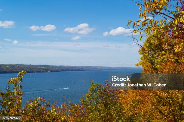 Watercraft Navigate The Waters Of Cayuga Lake Which Is One Of The Finger Lakes In New York State During A Partly Cloudy Autumn Day Stock Photo - Download Image Now