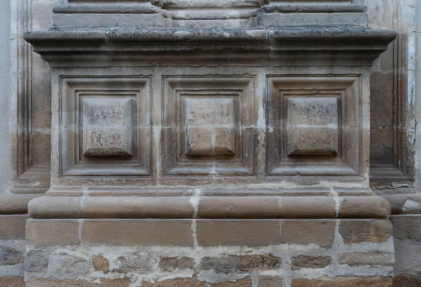 istock Stone wall craved into pictures 1289770410