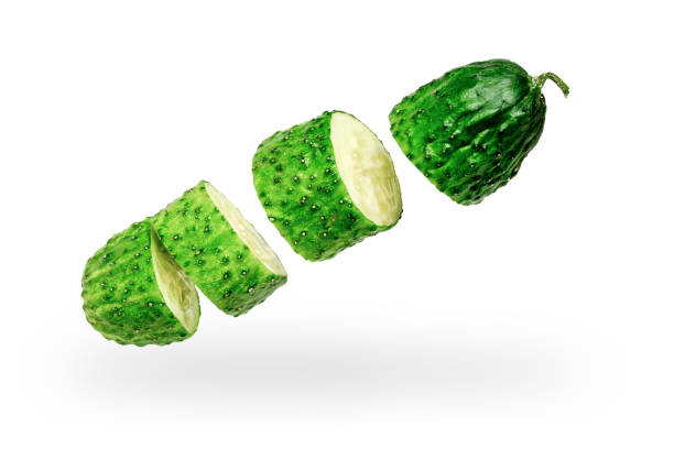 Cucumber cut into pieces on a white background Cucumber cut into pieces on a white background. Isolated. Levitation levitation stock pictures, royalty-free photos & images