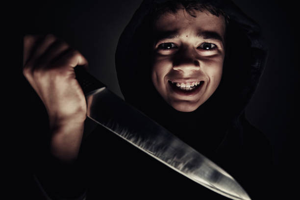 Boy in hoodie with knife in hand. Violent boy. Juvenile delinquent concept Boy in a hoodie with knife in hand. Violent boy. Juvenile delinquent concept murderer photos stock pictures, royalty-free photos & images