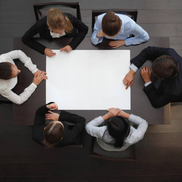 istock Business people around blank paper 1289776036