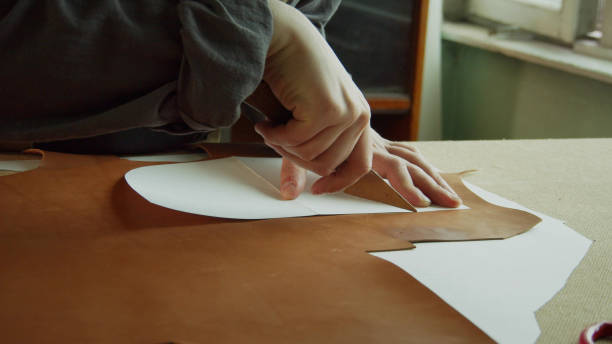 istock Creating original products made of genuine leather. Preparing and cutting out elements of exclusive shoes 1289776470