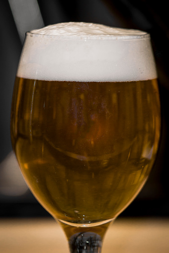 Closeup shot of glass of tasty craft beer, american pale ale