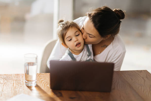istock Happy Caucasian mother working from home 1289777863