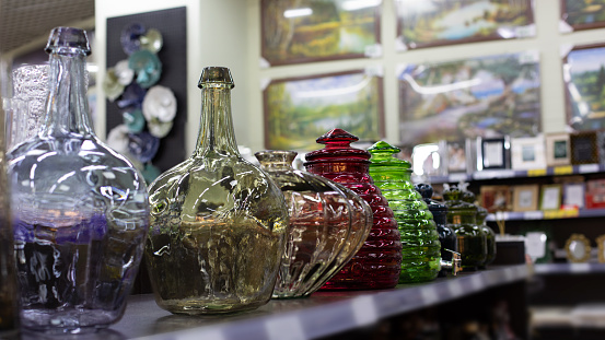 Colored glass bottles and vases of various shapes. Beautiful glass vessel for decoration and design