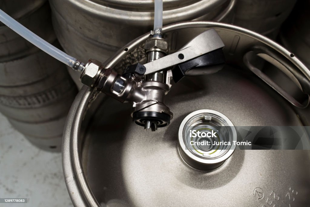Top view of a beer keg with a detached coupler and pipes Keg Stock Photo