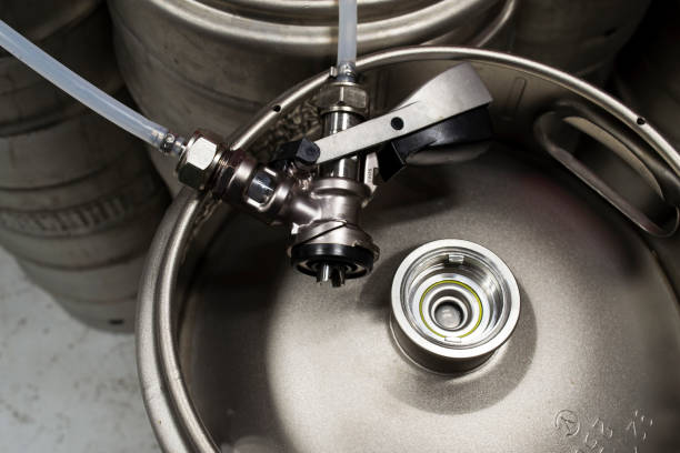 Top view of a beer keg with a detached coupler and pipes Top view of a beer keg with a detached coupler and pipes keg stock pictures, royalty-free photos & images