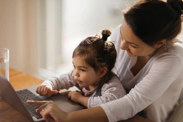 istock Happy Caucasian mother working from home 1289778092