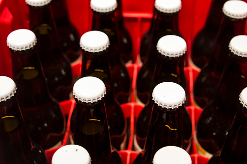Craft beer botles in a box, selective focus