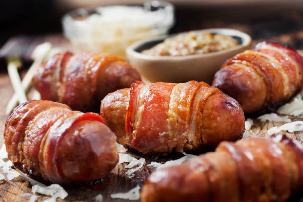 istock Mini Bacon Wrapped Bratwurst Sausages with  Sauerkraut and Grainy Mustard 1289778200
