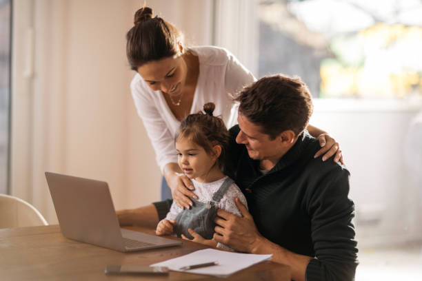 istock Happy Caucasian parents working from home 1289778215