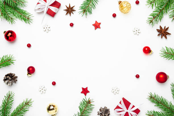 istock Christmas frame made of fir tree branches, holiday decorations and gift boxes on white background. flat lay 1289781125