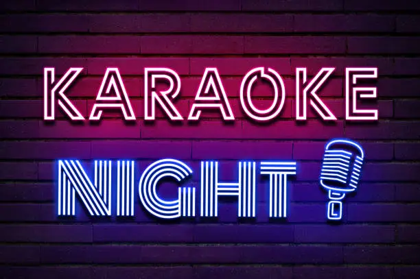 Photo of Karaoke night vintage microphone icon glowing purple violet neon text on brick wall