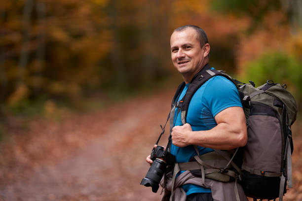 istock Nature photographer shooting fall scene in the forest 1289783388