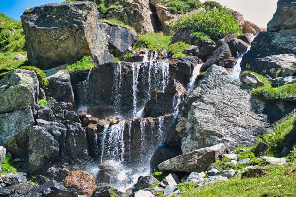 Picturesque waterfall in summer mountain gorge